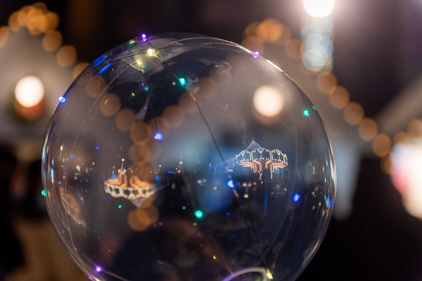 A karácsonyi fényeket nem csak a gömb töri meg, tükrözik a gyerekek kezében táncot járó luftballonok is, amelyekkel az egész tér tele van esténként. Színesen pislákoló fényeivel a város minden részén találkozhatunk. A csöppségek szorosan magukhoz ölelik a hazafele vezető úton.