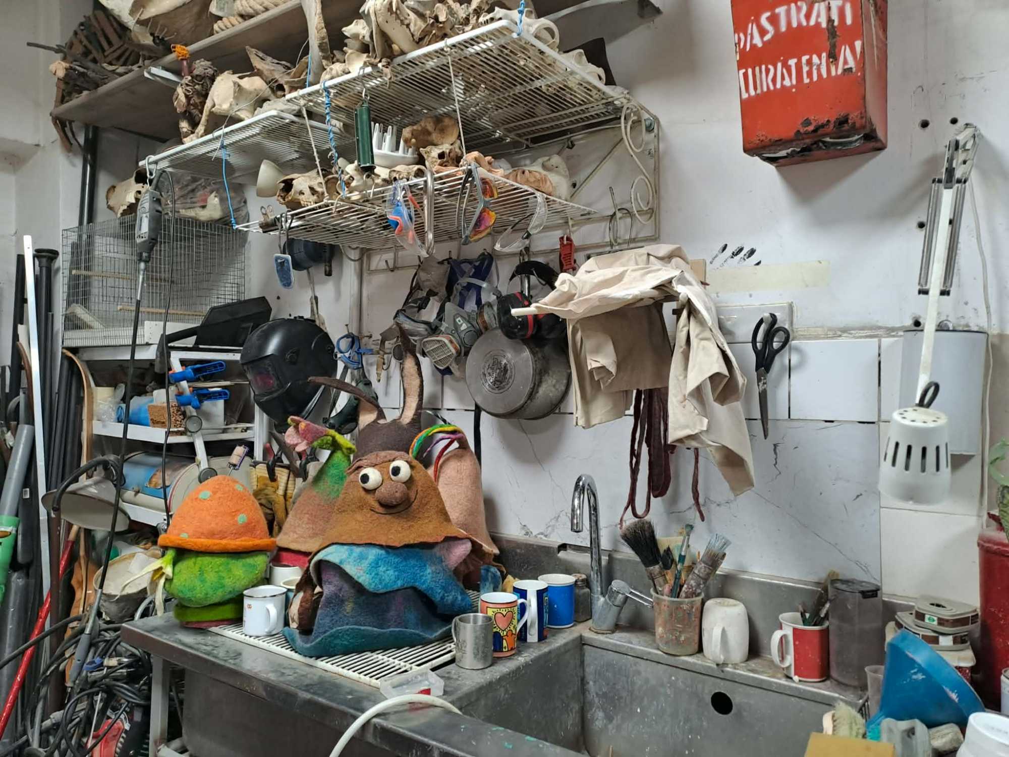 A műhely kis lak&oacute;i ek&ouml;zben rend&iacute;thetetlen&uuml;l figyelnek arra, mi k&eacute;sz&uuml;l a hatalmas asztalon.